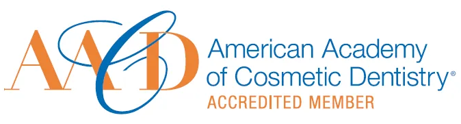The image shows a logo with text that includes the letters  AACD,   American Academy of Cosmetic Dentistry,  and other elements such as a stylized letter  a  and a graphic element resembling a toothbrush.